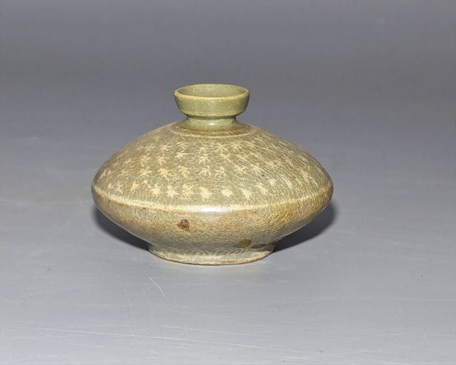 Lot 14, a Korean Goryeo slip-inlaid celadon oil bottle