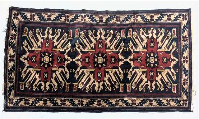 An antique Caucasian Seychour rug, woven with serrated star medallions